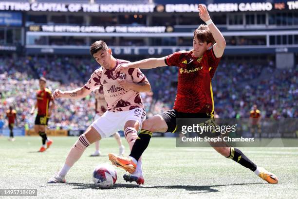 Claudio Bravo of Portland Timbers and Cody Baker of Seattle Sounders battle for the ball during the first half at Lumen Field on June 03, 2023 in...