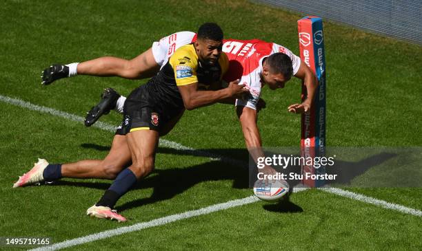 Hull KR player Ryan Hall scores a try despite the efforts of Salford player Kallum Watkins during the Betfred Super League Magic Weekend match...