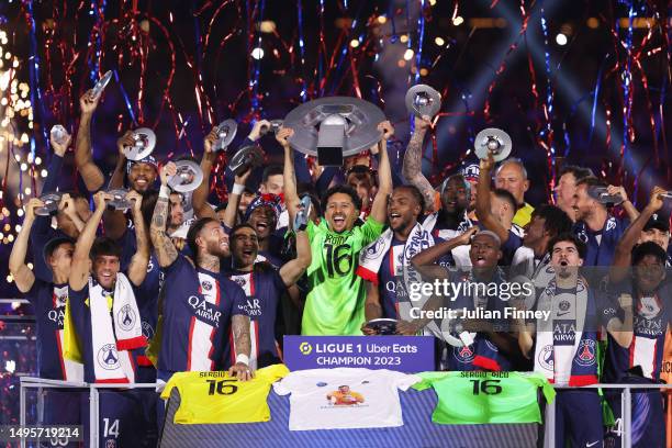 Marquinhos of Paris Saint-Germain, wearing a match shirt featuring the name of Sergio Rico and number 16, lifts the Ligue 1 Uber Eats trophy as...