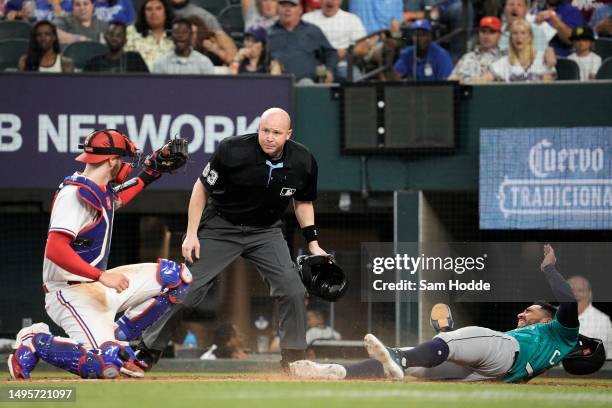 Jonah Heim of the Texas Rangers tags out Jose Caballero of the Seattle Mariners at home during the fourth inning at Globe Life Field on June 03, 2023...