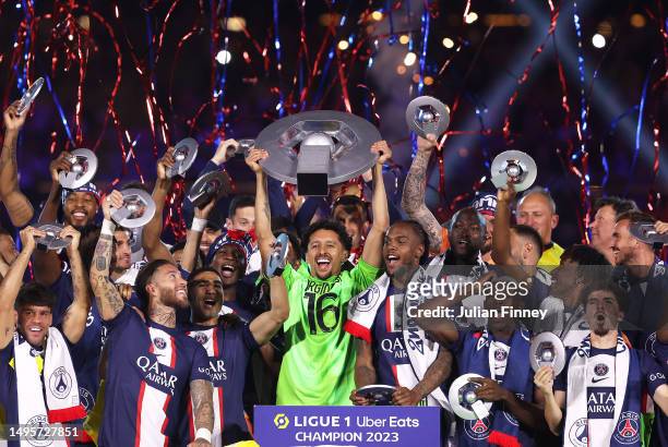 Marquinhos of Paris Saint-Germain, wearing a match shirt featuring the name of Sergio Rico and number 16, lifts the Ligue 1 Uber Eats trophy after...