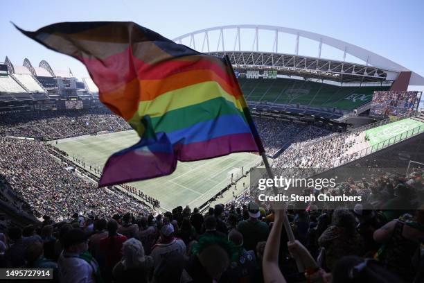 Fan waves a Pride flag before the game between the Seattle Sounders and the Portland Timbers at Lumen Field on June 03, 2023 in Seattle, Washington.