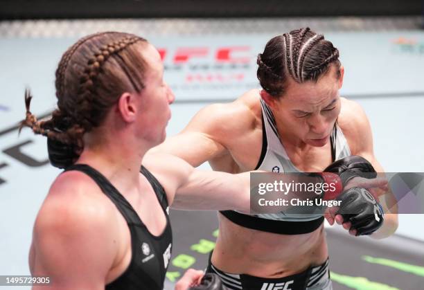 Elyse Reed Elise Reed punches Jinh Yu Frey in a strawweight bout during the UFC ...