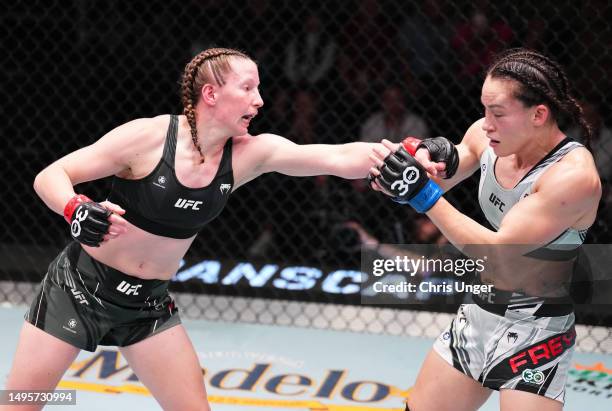Elyse Reed Elise Reed punches Jinh Yu Frey in a strawweight bout during the UFC ...