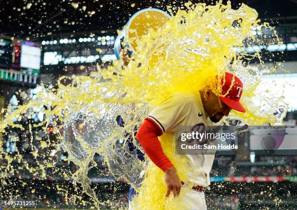 Marcus Semien of the Texas Rangers is doused with sports drink after the game against the Seattle Mariners at Globe Life Field on June 03, 2023 in...