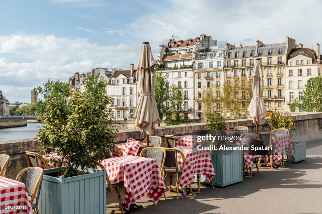 Cafe on the bank of Seine river on a sunny day, Paris, France