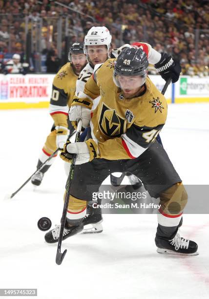 Brandon Montour of the Florida Panthers and Ivan Barbashev of the Vegas Golden Knights battle for the puck during the first period in Game One of the...