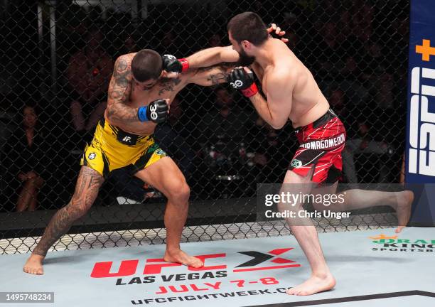 Abubakar Nurmagomedov of Russia punches Elizeu Zaleski dos Santos of Brazil in a welterweight bout during the UFC Fight Night event at UFC APEX on...