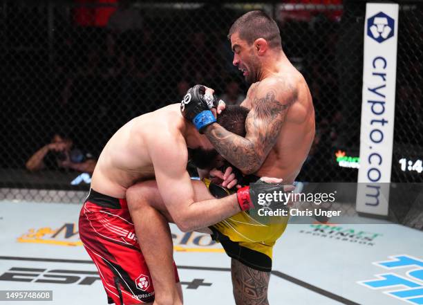 Elizeu Zaleski dos Santos of Brazil knees the body of Abubakar Nurmagomedov of Russia in a welterweight bout during the UFC Fight Night event at UFC...