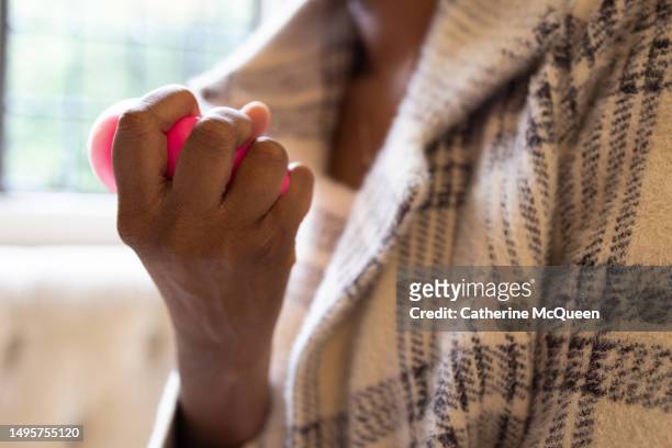 black woman holding stress squeeze ball - stress ball stock pictures, royalty-free photos & images