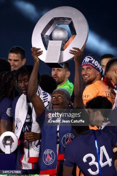 Nuno Mendes of PSG lifts the Ligue 1 Uber Eats trophy following the Ligue 1 match between Paris Saint-Germain and Clermont Foot 63 at Parc des...