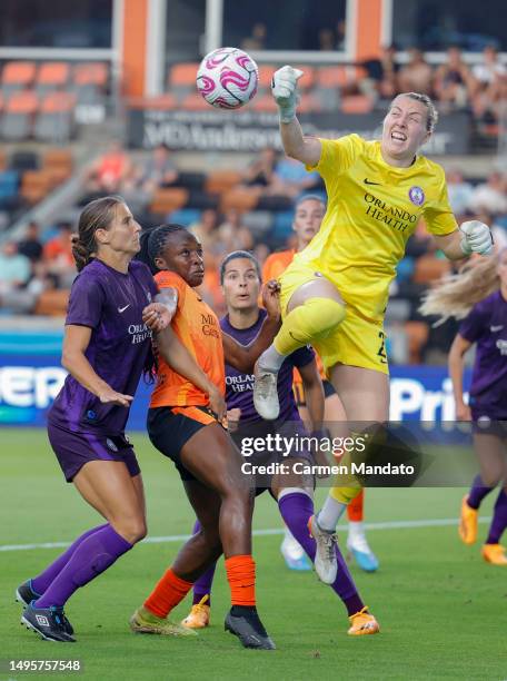 Anna Moorehouse of Orlando Pride punches away a shot on goal ahead of Michelle Alozie of the Houston Dash during the first half at Shell Energy...