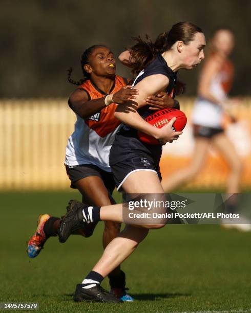 Johanna Sunderland of the Falcons is tackled by Marika Carlton of Northern Territory during the round nine Coates Talent League Girls match between...