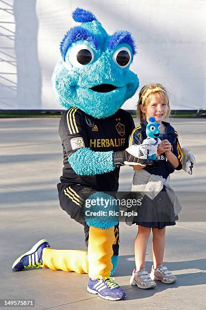 Los Angeles Galaxy mascot "Cozmo" poses with a young fan before the international friendly match against Tottenham Hotspur at The Home Depot Center...