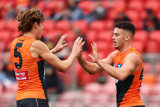 Aaron Cadman and Jake Riccardi of the Giants celebrate Jake Riccardi kicking a goal during the round 12 AFL match between Greater Western Sydney...