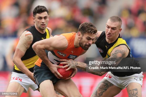 Stephen Coniglio of the Giants is tackled by Dustin Martin of the Tigers during the round 12 AFL match between Greater Western Sydney Giants and...