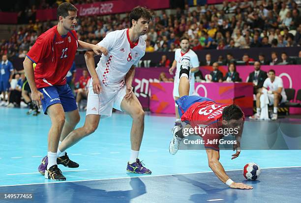 Nenad Vuckovic of Serbia trips during the Men's Handball Preliminary match between Serbia and Croatia on Day 4 of the London 2012 Olympic Games at...