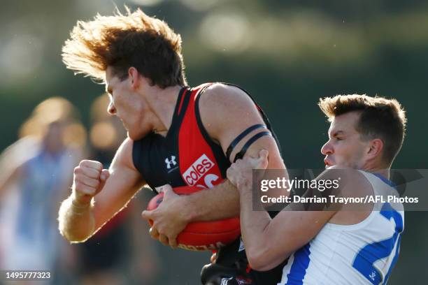 Kaine Baldwin of Essendon is tackled by Kayne Turner of North Melbourneduring the round 11 VFL match between Essendon Bombers and North Melbourne...