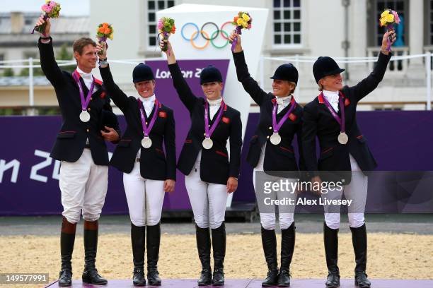 The Great Britain team celebrate on the podium after winning the Silver medal in the Eventing Team Jumping Final Equestrian event on Day 4 of the...