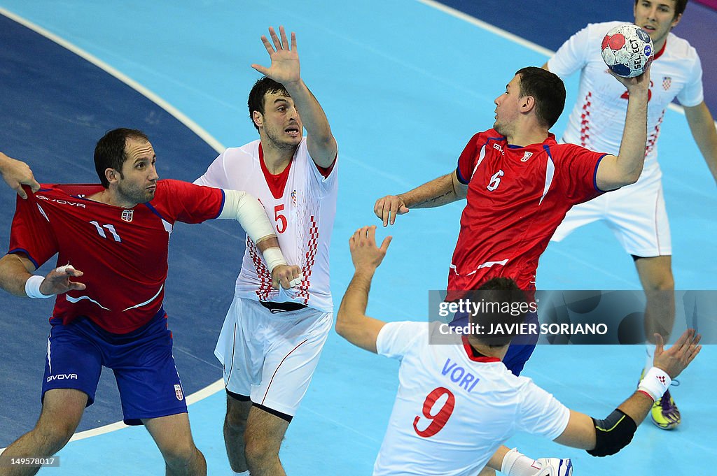 Serbia's Marko Vujin (R) jumps to shoot 