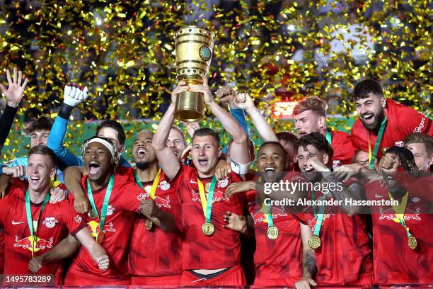 Willi Orban of RB Leipzig lifts the DFB Cup trophy after the team's victory during the DFB Cup final match between RB Leipzig and Eintracht Frankfurt...