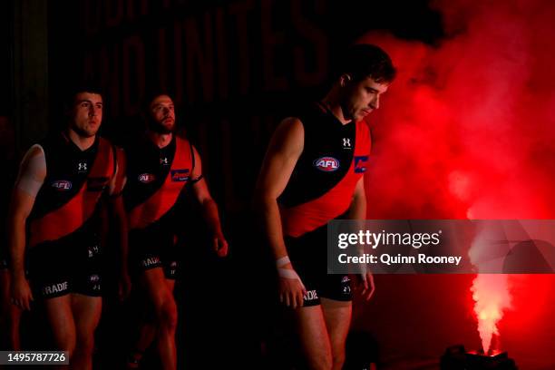 Zach Merrett of the Bombers leads his team out onto the field during the round 12 AFL match between Essendon Bombers and North Melbourne Kangaroos at...
