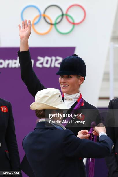Zara Phillips is presented a silver medal by her mother, Princess Anne, Princess Royal after the Eventing Team Jumping Final Equestrian event on Day...