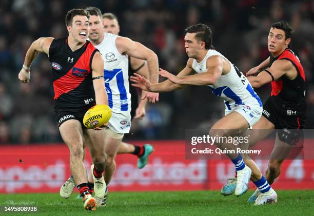 Zach Merrett of the Bombers handballs during the round 12 AFL match between Essendon Bombers and North Melbourne Kangaroos at Marvel Stadium, on June...