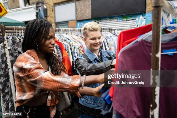 londoners browsing clothes racks at outdoor flea market - feira da ladra mercado imagens e fotografias de stock