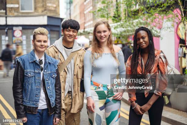 outdoor portrait of four gen z friends on brick lane - brick lane inner london stock pictures, royalty-free photos & images