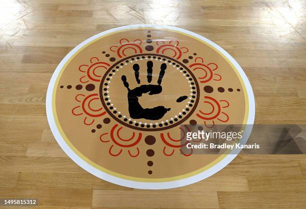 Indigenous artwork is seen on the centre court during the round 12 Super Netball match between Queensland Firebirds and Melbourne Vixens at Nissan...