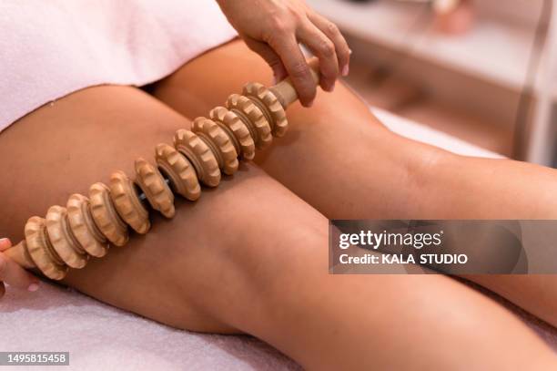 person receiving a maderotherapy treatment at a spa - massager stock pictures, royalty-free photos & images