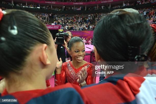 Gymnast Gabrielle Douglas and teammates celebrate winning gold in the women's team of the artistic gymnastics event of the London Olympic Games on...