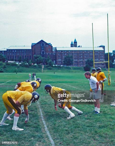 Assistant head coach George Perles of the Pittsburgh Steelers watches as defensive linemen practice during summer training camp on the campus of...