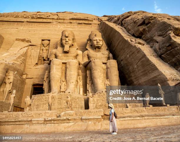 a female tourist contemplating at abu simbel temple (great temple of ramses ii) in egypt. - ancient civilization stock-fotos und bilder