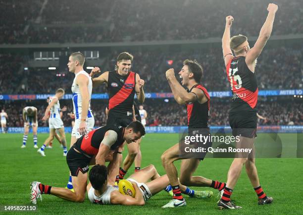 Kyle Langford, Sam Durham, Nic Martin and Jayden Laverde of the Bombers celebrate winning the round 12 AFL match between Essendon Bombers and North...