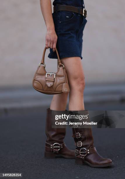 Lea Naumann wearing Miu Miu brown leather boots, vintage brown leather belt, GStar denim off shoulder mini dress, Bottega Veneta brown shades and...