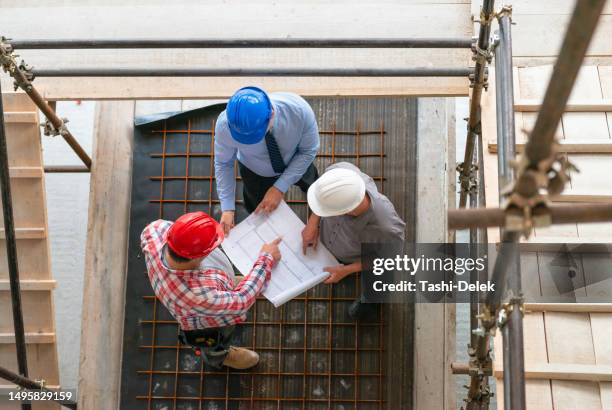 architect, engeneer and foreman on a construction site - real estate developer stock pictures, royalty-free photos & images