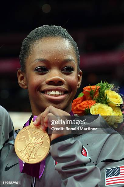 Gabrielle Douglas of the United States poses with the gold medal after helping the United States win the Artistic Gymnastics Women's Team final on...