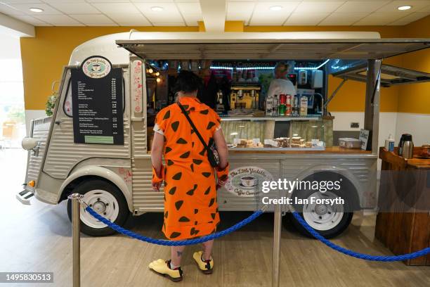 Man dressed as the character Fred Flintstone waits for a coffee during Comic-con Yorkshire on June 04, 2023 in Harrogate, England. Comic Cons are...