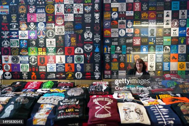 Stall holder selling t-shirts sits at her stand during Comic-con Yorkshire on June 04, 2023 in Harrogate, England. Comic Cons are held worldwide with...