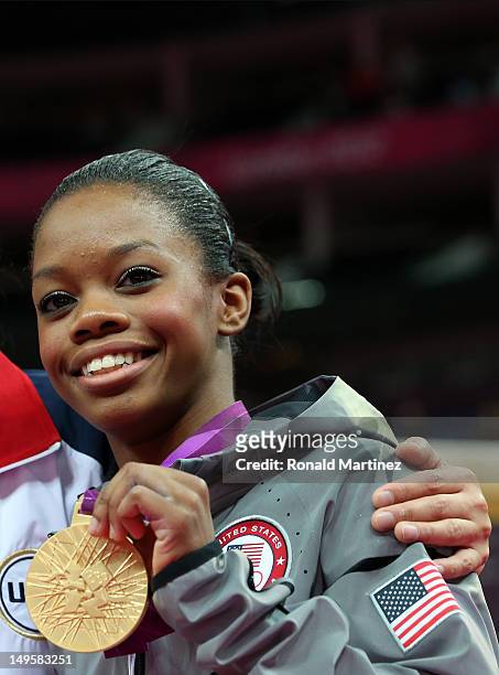 Gabrielle Douglas of the United States poses with the gold medal after helping the United States win the Artistic Gymnastics Women's Team final on...