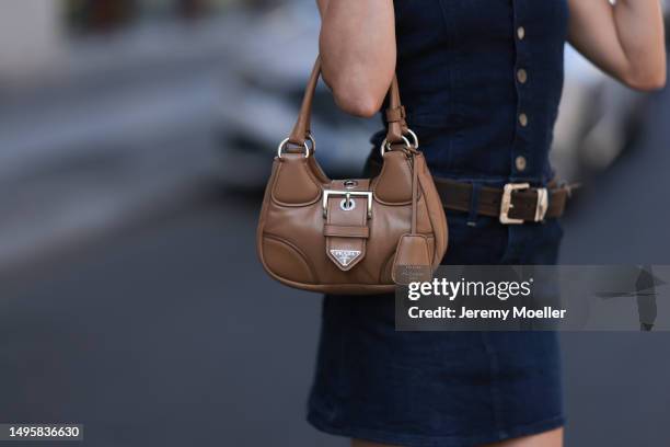 Lea Naumann wearing Miu Miu brown leather boots, vintage brown leather belt, GStar denim off shoulder mini dress, Bottega Veneta brown shades and...