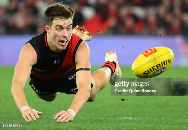 Zach Merrett of the Bombers dives for the ball during the round 12 AFL match between Essendon Bombers and North Melbourne Kangaroos at Marvel...