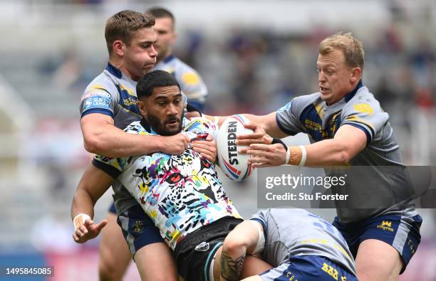 Leigh player Ricky Leutele is wrapped up by the Wakefield defence during the Betfred Super League Magic Weekend match between Wakefield Trinity and...