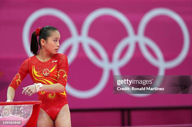 Jinnan Yao of China puts her hand in the chalk in the Artistic Gymnastics Women's Team final on Day 4 of the London 2012 Olympic Games at North...