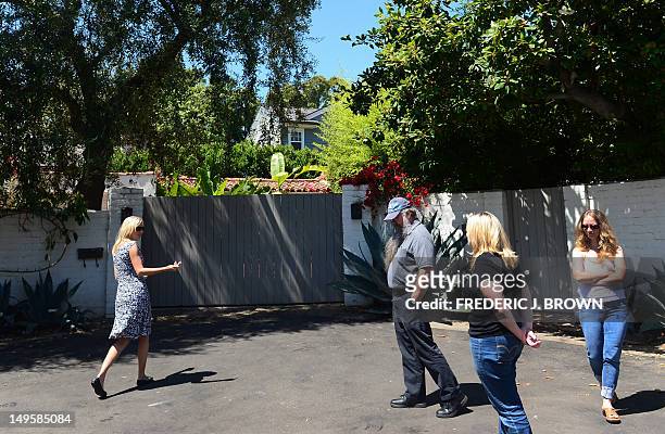Tour guide Elisa Jordan and her group arrive outside the house where Marilyn Monroe died in Brentwood, on July 28, 2012 in California, during a tour...