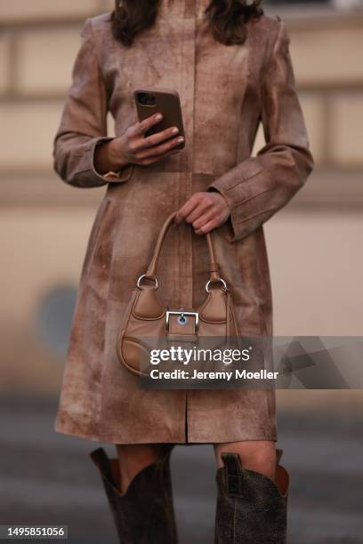 Lea Naumann wearing Vintage beige leather shoulder pads coat, Diesel brown leather boots, Prada beige leather Moon bag and New York grey capon June...