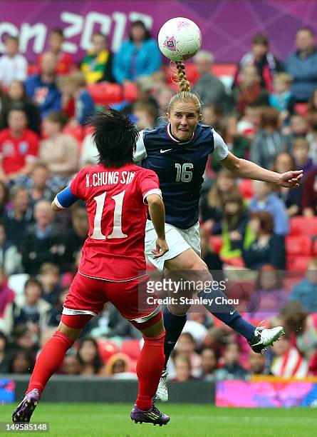 Rachel Buehler of USA is tackled by Kim Chung Sim of DPR Korea during the Women's Football first round Group G match between the United States and...