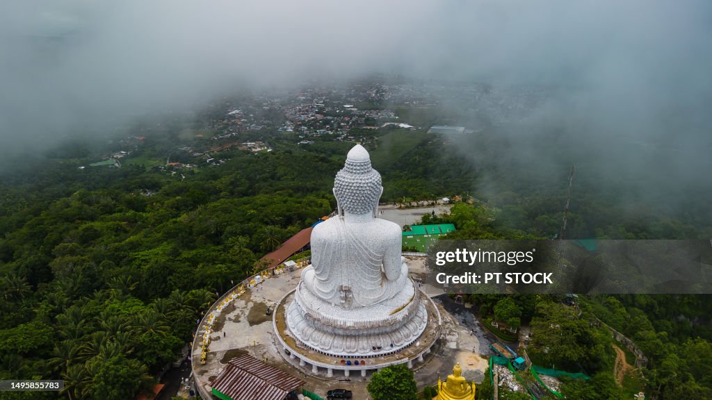 Aerial view. Big Buddha, Phuket, Thailand. During the rainy season, heavy rain causes fog to rise from the mountains. And tourists keep coming to Phuket Big Buddha and it's amazing that Phuket Big Buddha is foggy.